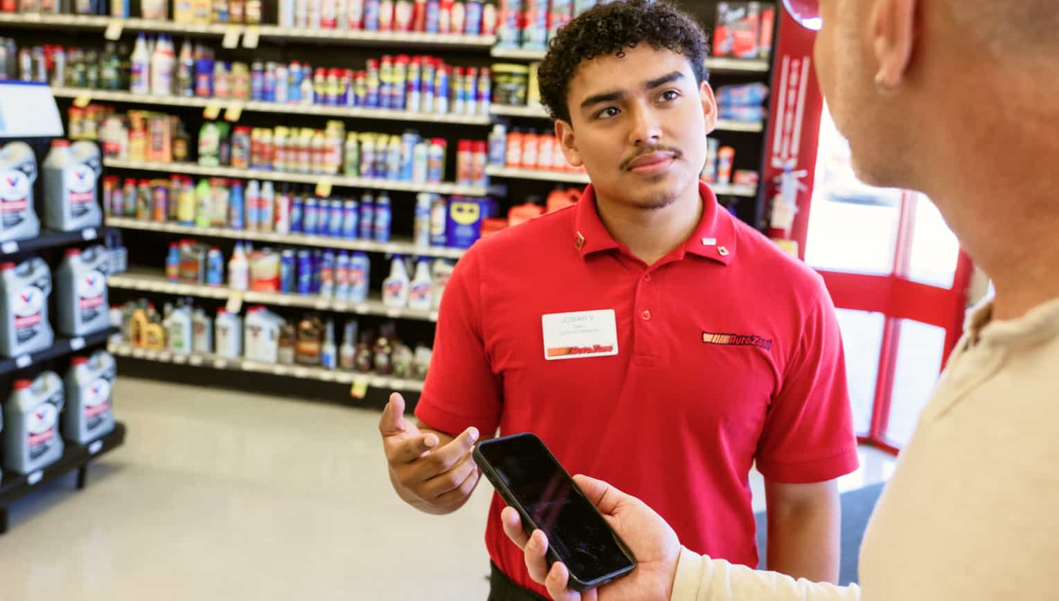 AutoZone employee assisting a customer